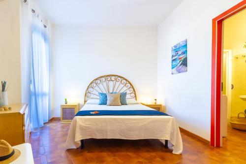 ein Schlafzimmer mit einem Bett mit blauen Kissen darauf in der Unterkunft Appartamento La Poesia Bilo - MyHo Casa in Tortoreto Lido