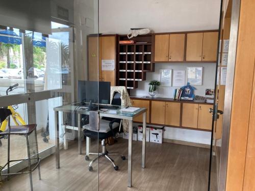 an office with a desk and a chair and cabinets at Malvarrosa Beach Rooms in Valencia