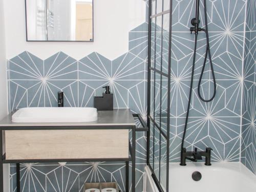 a bathroom with a shower and a sink at Ty Arth in Llandudno