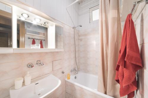 a bathroom with a white tub and a sink at Apartment Kazimierz Rzeszowska in Krakow