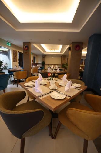 comedor con mesa de madera y sillas en PrideInn Westlands Luxury Boutique Hotel en Nairobi