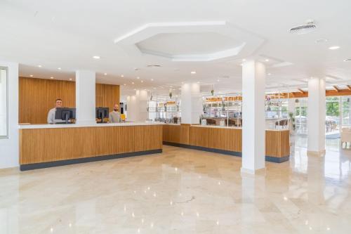 a lobby of a hospital with a reception counter at Aparthotel Ferrer Lime Isabel in Cala Bona