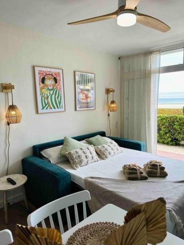 1 dormitorio con 2 camas, mesa y ventana en Apartamento Boutique en la Playa en La Pineda