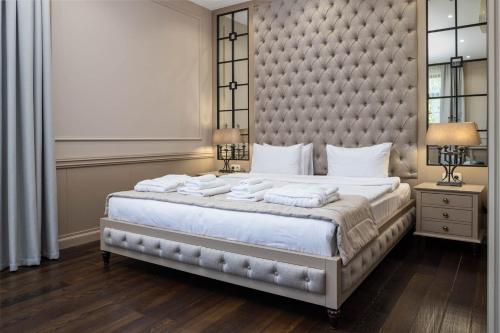 a bedroom with a large bed with a large headboard at Crona SPA Karpaty in Skhidnitsa
