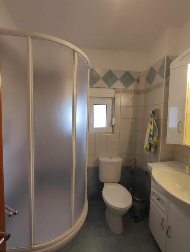 a bathroom with a shower and a toilet and a sink at EverGreen in Kavala