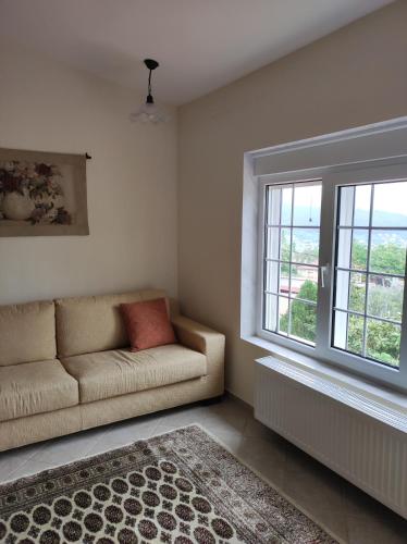 a living room with a couch and a window at EverGreen in Kavala