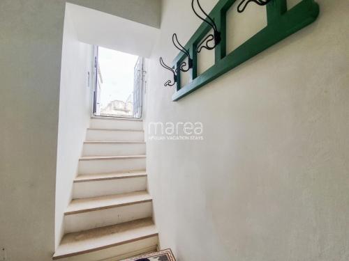 a staircase in a house with a window at La Torretta - Marea Stays Collection in Otranto