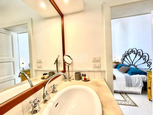 a bathroom with a sink and a mirror at La Torretta - Marea Stays Collection in Otranto