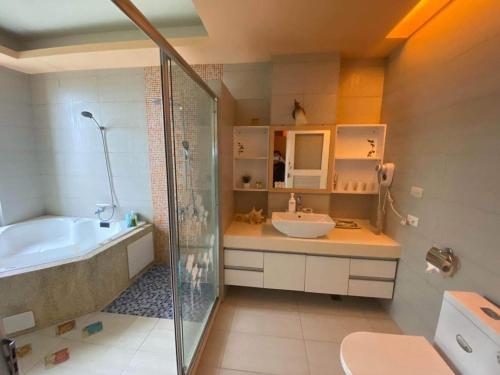 a bathroom with a tub and a sink and a shower at MorningSue Homestay in Hualien City