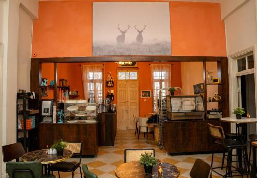 a room with orange walls and tables and chairs at Jerusalem Boutique Hotel in Jerusalem