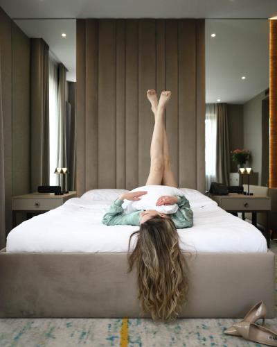 a woman laying on a bed with her legs in the air at Crona SPA Karpaty in Skhidnitsa