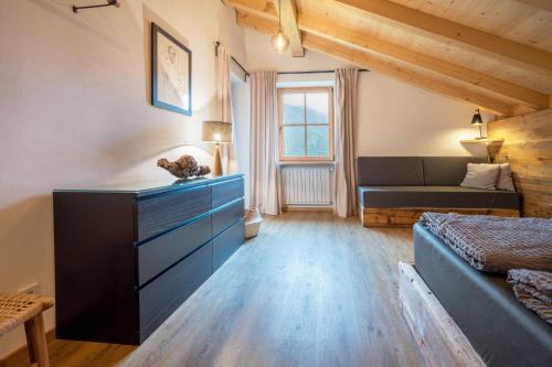a bedroom with a blue dresser and a bed at Valentin36 Apartment Ritten in Funes