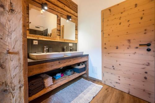 a bathroom with a sink and a mirror at Valentin36 Apartment Ritten in Funes