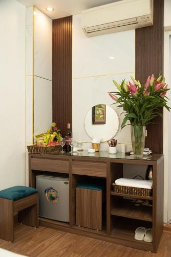 a bathroom with a vanity and a mirror at HOTTEL HÀ THÀNH in Hanoi