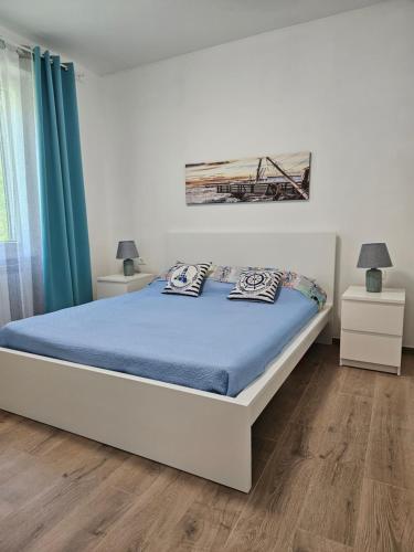 a bedroom with a bed with blue sheets and blue curtains at Casa Marina in Ortona