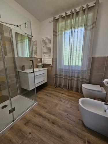a bathroom with a sink and a toilet and a mirror at Casa Marina in Ortona