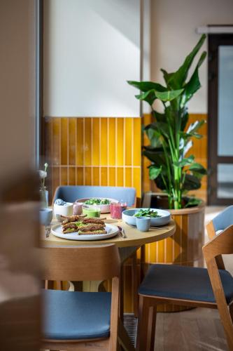 a table with a plate of food on it at Almanac X Alcron Prague in Prague