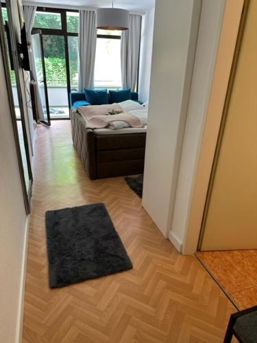 a hallway with a bedroom with a bed and a rug at Pension COLUMBIA inkl. Frühstück im Zentraum in Bad Gleichenberg
