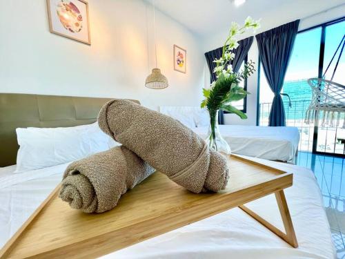 a stuffed animal is laying on a bed at P 1-5Pax Cozy Home Setia Alam Trefoil Smrt TV&Wifi in Setia Alam