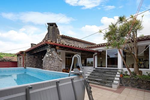 a house with a swimming pool in front of a house at Vila Nova House in Laseira