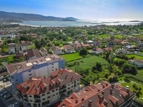 an aerial view of a city with a body of water at Costaserenasuites in Nigrán