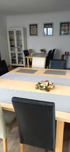 a table with flowers on top of it with chairs at A-Piramida in Wrocław