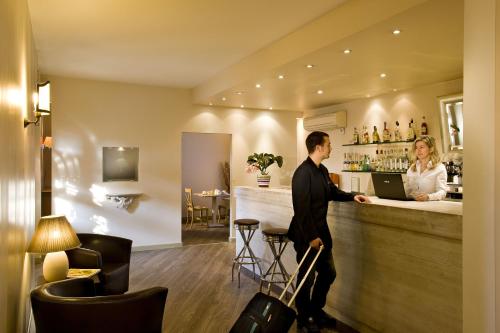 Ein Mann steht mit einer Frau in einer Bar. in der Unterkunft Hotel Noce in Brescia