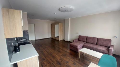 a living room with a couch and a table at Comfy room near city centre in Tallinn