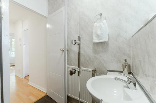 a white bathroom with a sink and a shower at Holloway Road Double rooms - 5 in London