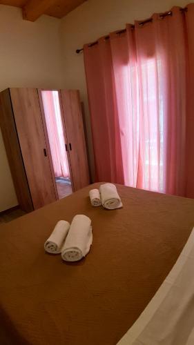 a bedroom with a bed with two towels on it at Casanuova Flat, City Center in Olbia