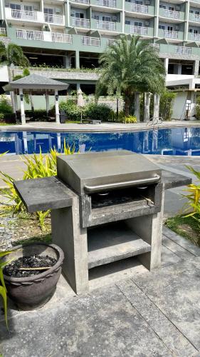 a concrete bench sitting next to a swimming pool at Verdon Parc Condo 1 Bedroom in Davao City