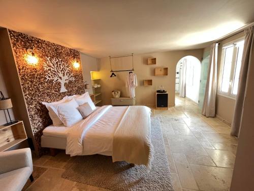 a bedroom with a large bed with a wall at Domaine de la Citerne in Nans-les-Pins