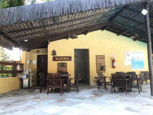 a restaurant with tables and chairs in front of a building at Riviera de São Lourenço Amarilis 302 in Bertioga