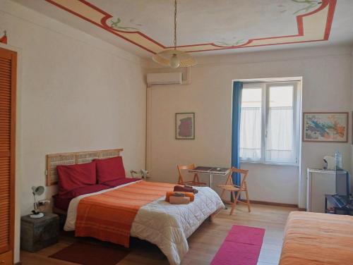 a bedroom with a bed and a table and a window at Torre Tonda in Sassari