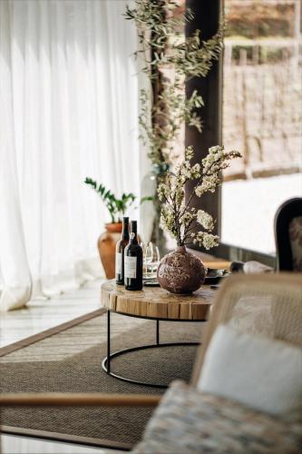 a table with bottles of wine on it in a living room at Casa do Santo - Wine & Tourism in Provesende