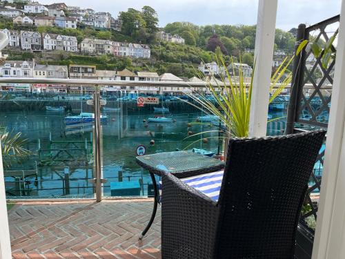 a balcony with a view of a marina at Shellseekers Guest House in Looe