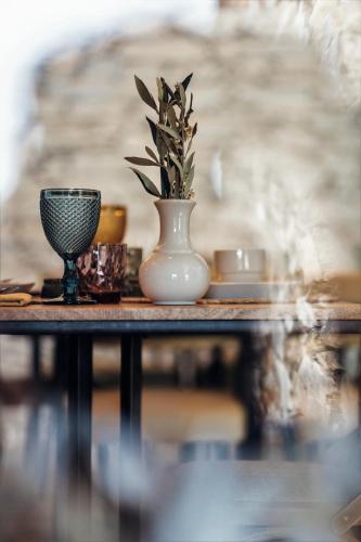 a vase with a plant in it sitting on a table at Casa do Santo - Wine & Tourism in Provesende