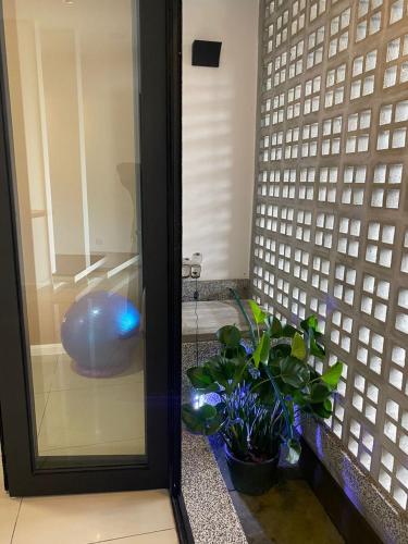 a bathroom with a mirror and some plants at Timurahaus in Kajang