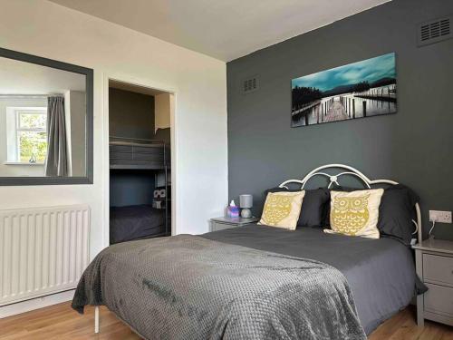 a bedroom with a bed in a room with a window at Netherby Grange Garden Apartment with Sea Views in Llandrillo-yn-Rhôs