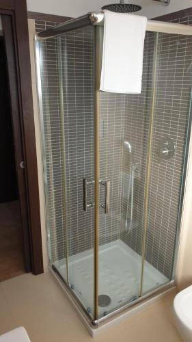 a shower with a glass enclosure in a bathroom at Villa Ginevra Resort Agrituristico in Ficarra