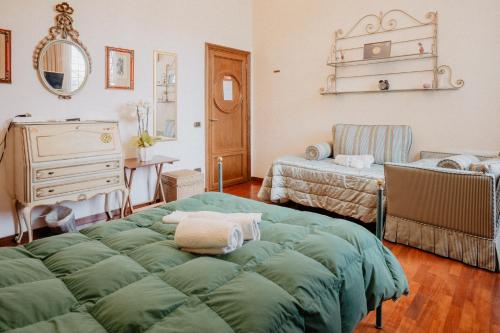 a bedroom with a bed and a dresser and a room with two beds at Villa Luigi XVI in Taranto