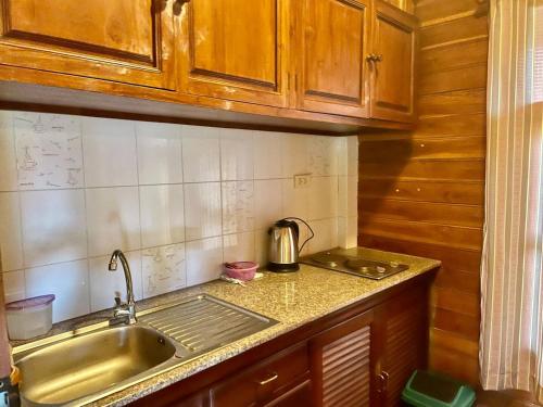 a kitchen with a sink and a counter top at Bangsaray Village Resort in Ban Nong Chap Tao