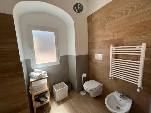 a small bathroom with a toilet and a window at V12 Apartments Puglia Modugno in Modugno