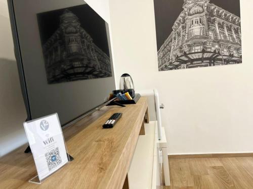 a desk in a room with a picture of a building at V12 Apartments Puglia Modugno in Modugno