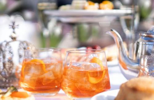a group of glasses filled with orange juice on a table at Prestonfield House in Edinburgh