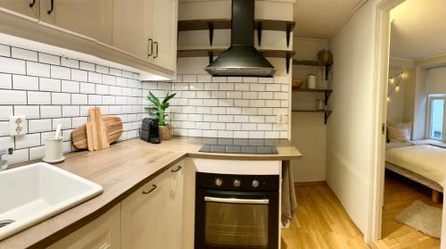 a kitchen with a sink and a stove top oven at steinkjellergaten in Bergen