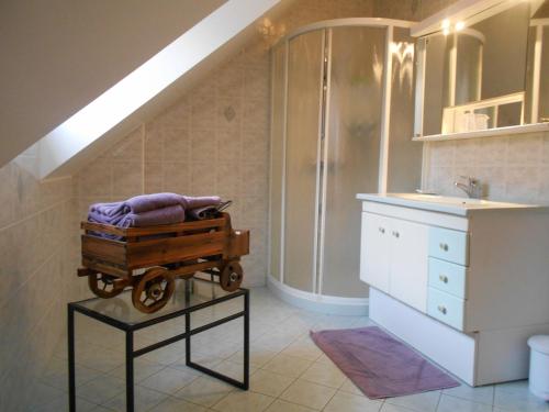 a bathroom with a cart with a sink and a staircase at chez jocelyne la bonnaventure in Mazangé