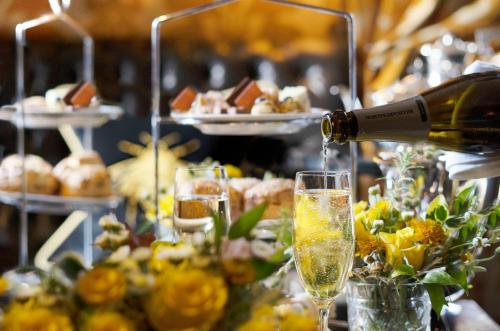 a bottle of wine is being poured into a glass at Prestonfield House in Edinburgh