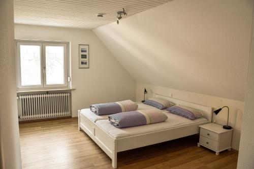 a bedroom with a bed with two pillows on it at am Hohlebach in Schliengen