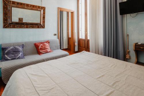a hotel room with a bed and a couch at Villa Luigi XVI in Taranto